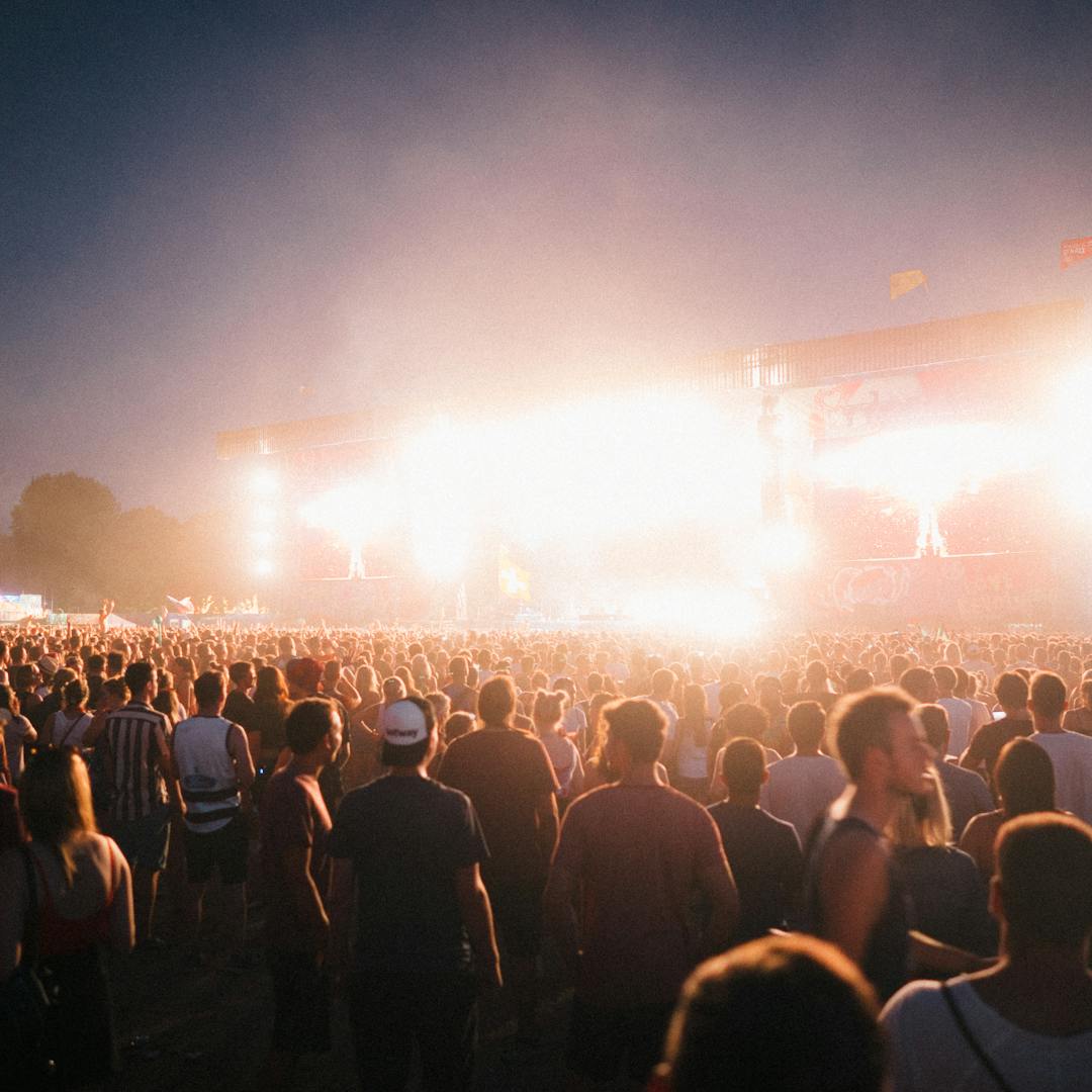 Coachella festival crowd at night with stage lights